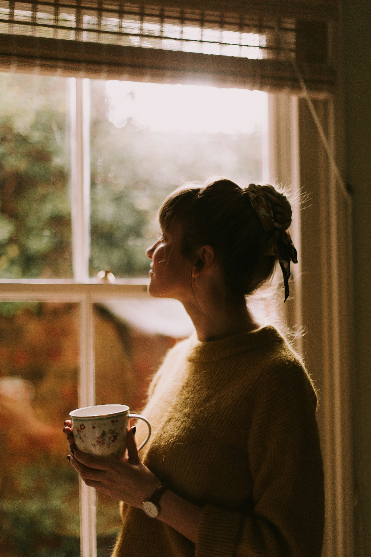 A grounded leader by a sunlit window